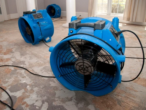 3 large blue fans drying out flooded basement