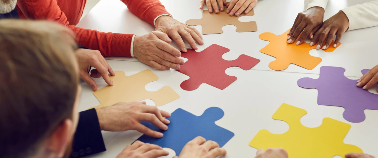 People fitting puzzle pieces together